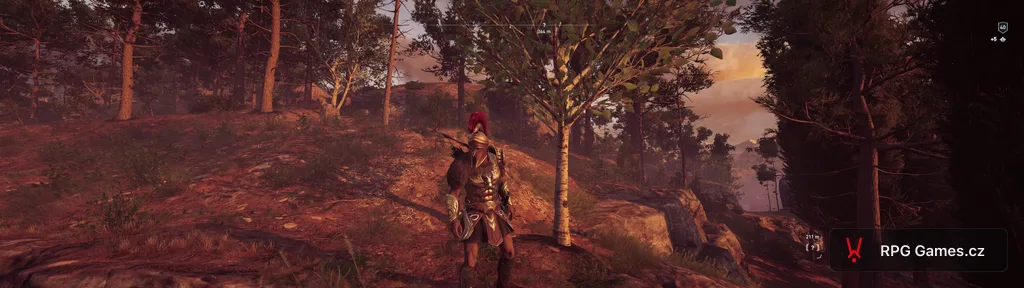 Assassin's Creed Odyssey na PC — Alexios v bronzové řecké zbroji na skalnatém svahu nad údolím při západu slunce